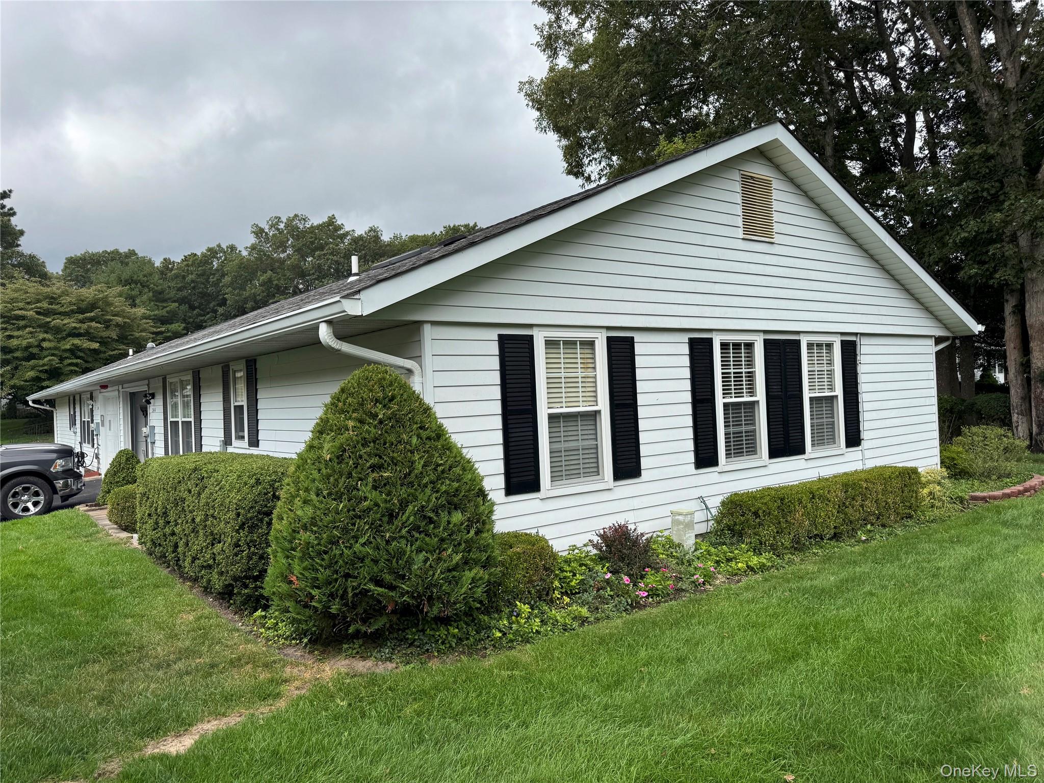 354 Woodbridge Drive, Unit A Ridge, NY 11961 - Photo 1 of 1 View of side of property featuring a yard