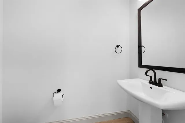 a bathroom with a sink and mirror