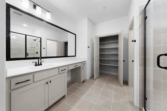 a bathroom with a double vanity sink mirror and