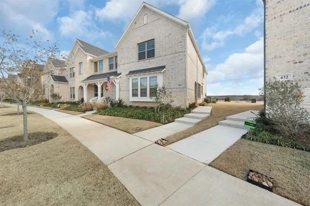 a view of a white apartments with large windows