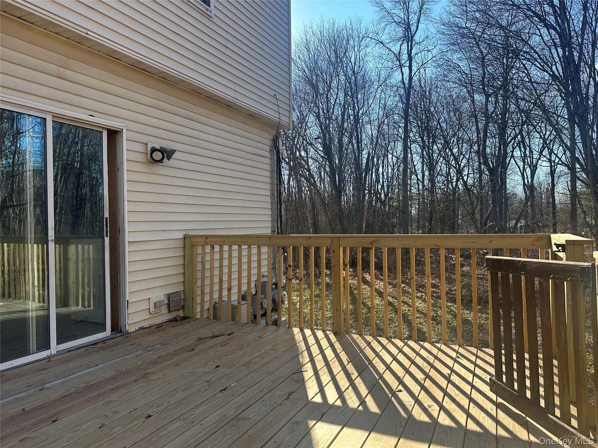 27 Dandelion Lane, Unit A Wallkill, NY 12589 - Photo 14 of 16 a balcony with wooden floor