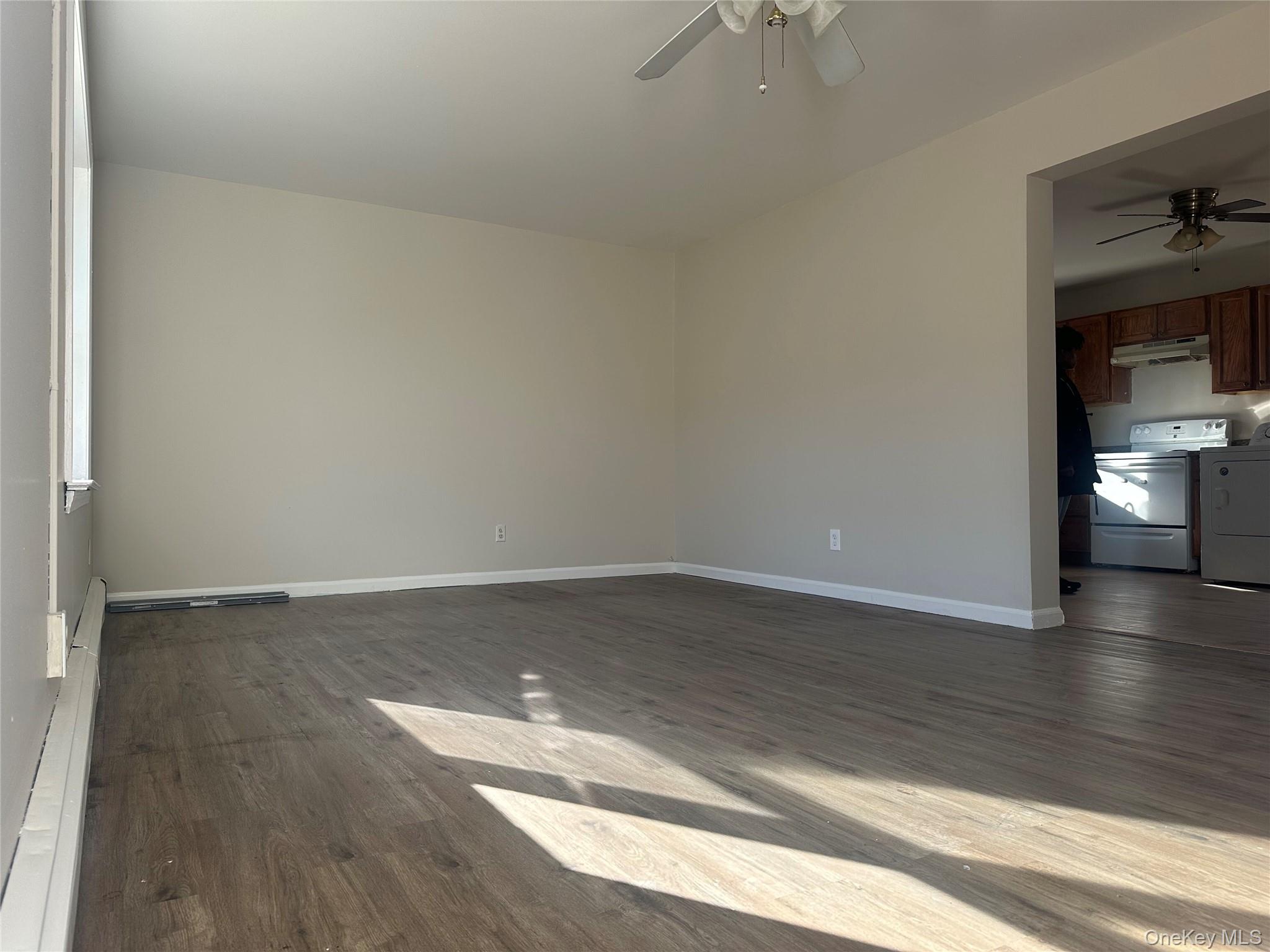 27 Dandelion Lane, Unit A Wallkill, NY 12589 - Photo 3 of 16 a view of an empty room and wooden floor and a window