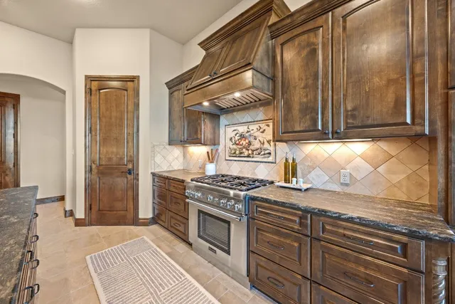 a kitchen with granite countertop lots of counter top space and stainless steel appliances
