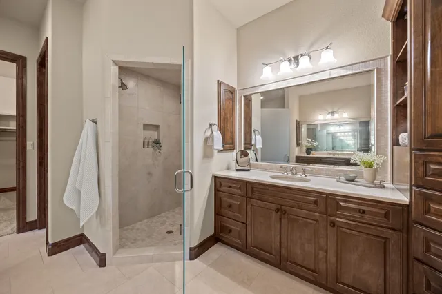 a bathroom with a double vanity sink and a mirror