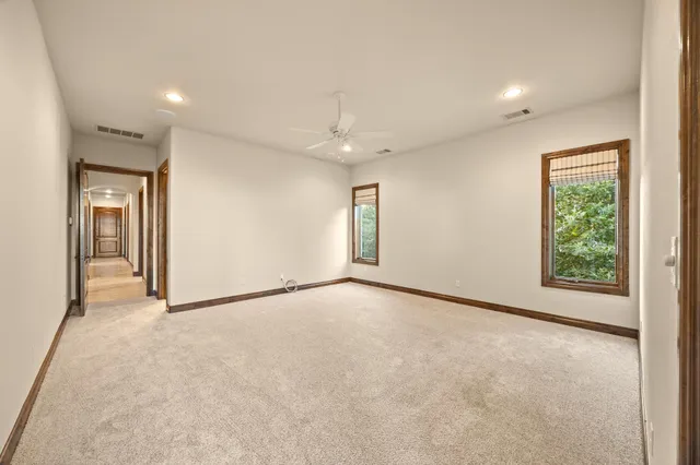 an empty room with windows and closet