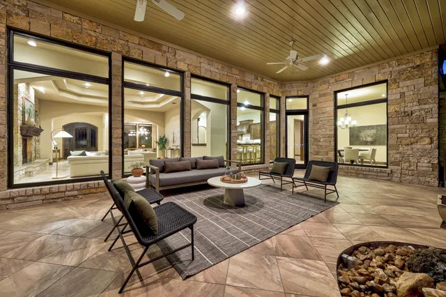 a living room with furniture and a floor to ceiling window
