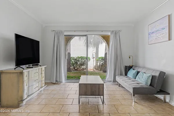 a living room with furniture and a flat screen tv