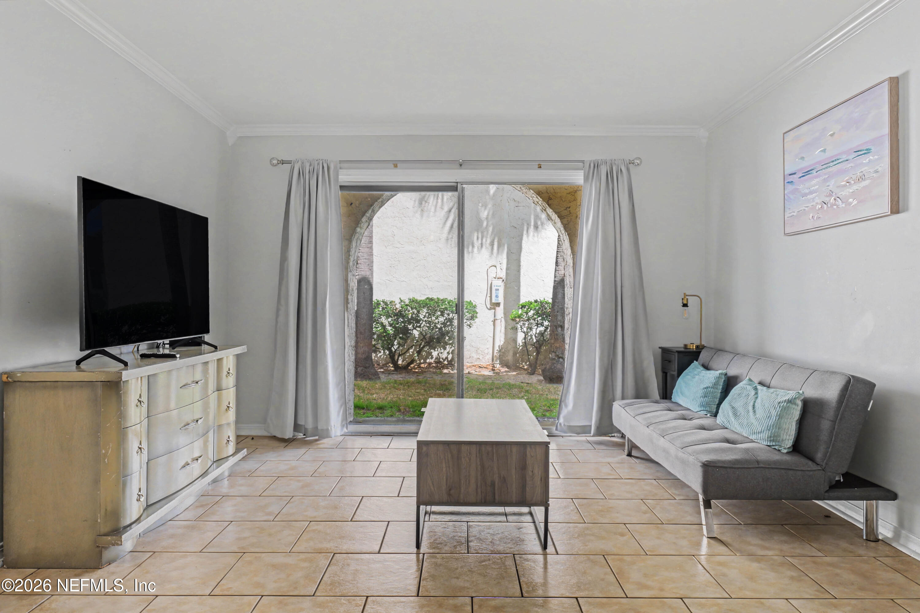 a living room with furniture and a flat screen tv