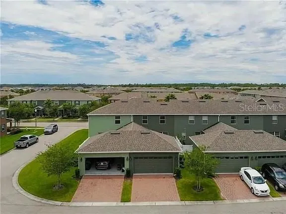 an aerial view of a house with swimming pool and mountains
