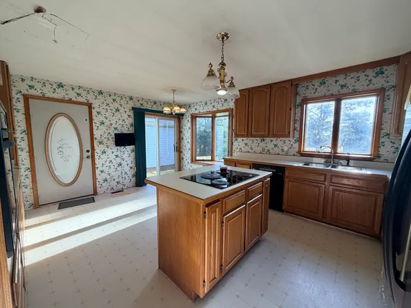 a kitchen with a stove top oven sink and cabinets