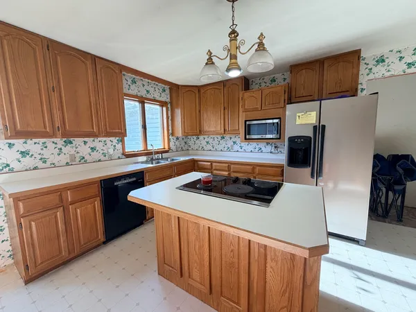 a kitchen with stainless steel appliances a sink stove and refrigerator