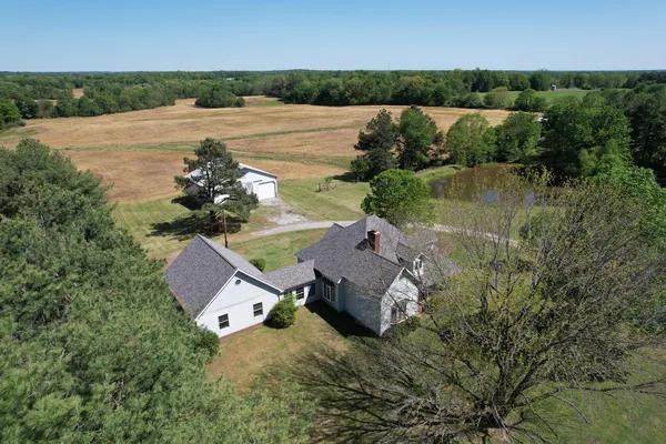 an aerial view of a house with a lake view
