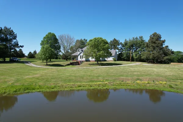 a view of a lake with houses in the background