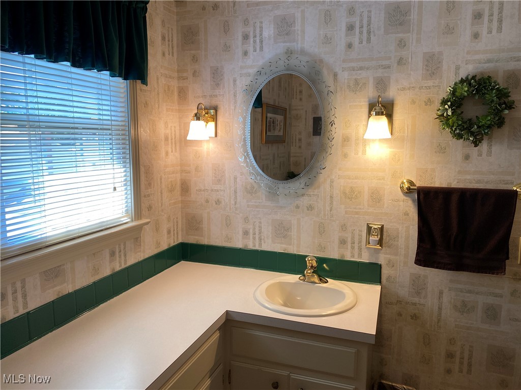2478 Barrington Road Akron, OH 44333 - Photo 19 of 23 The full bath located near the bedrooms boasts a window, decorative wall sconces and LTV flooring