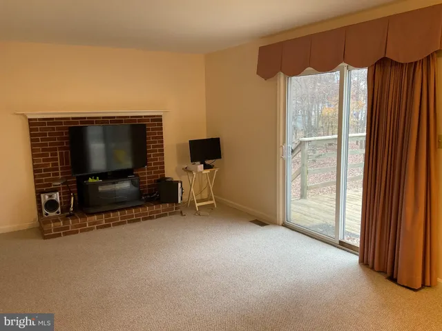 a view of livingroom with furniture and a flat screen tv