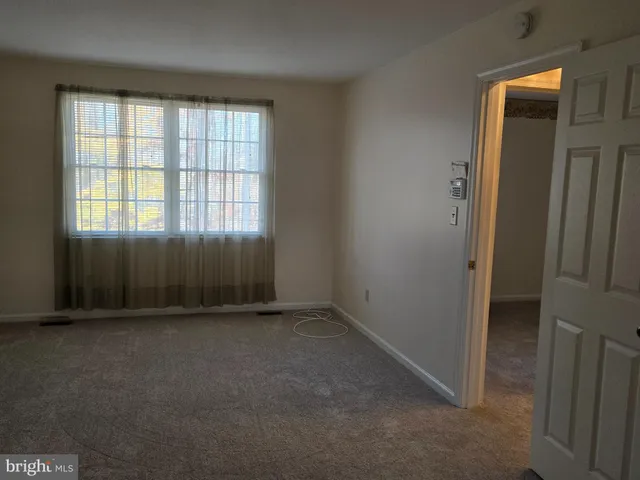 an empty room with a empty space and windows