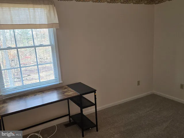 a room that has a window and a table in it