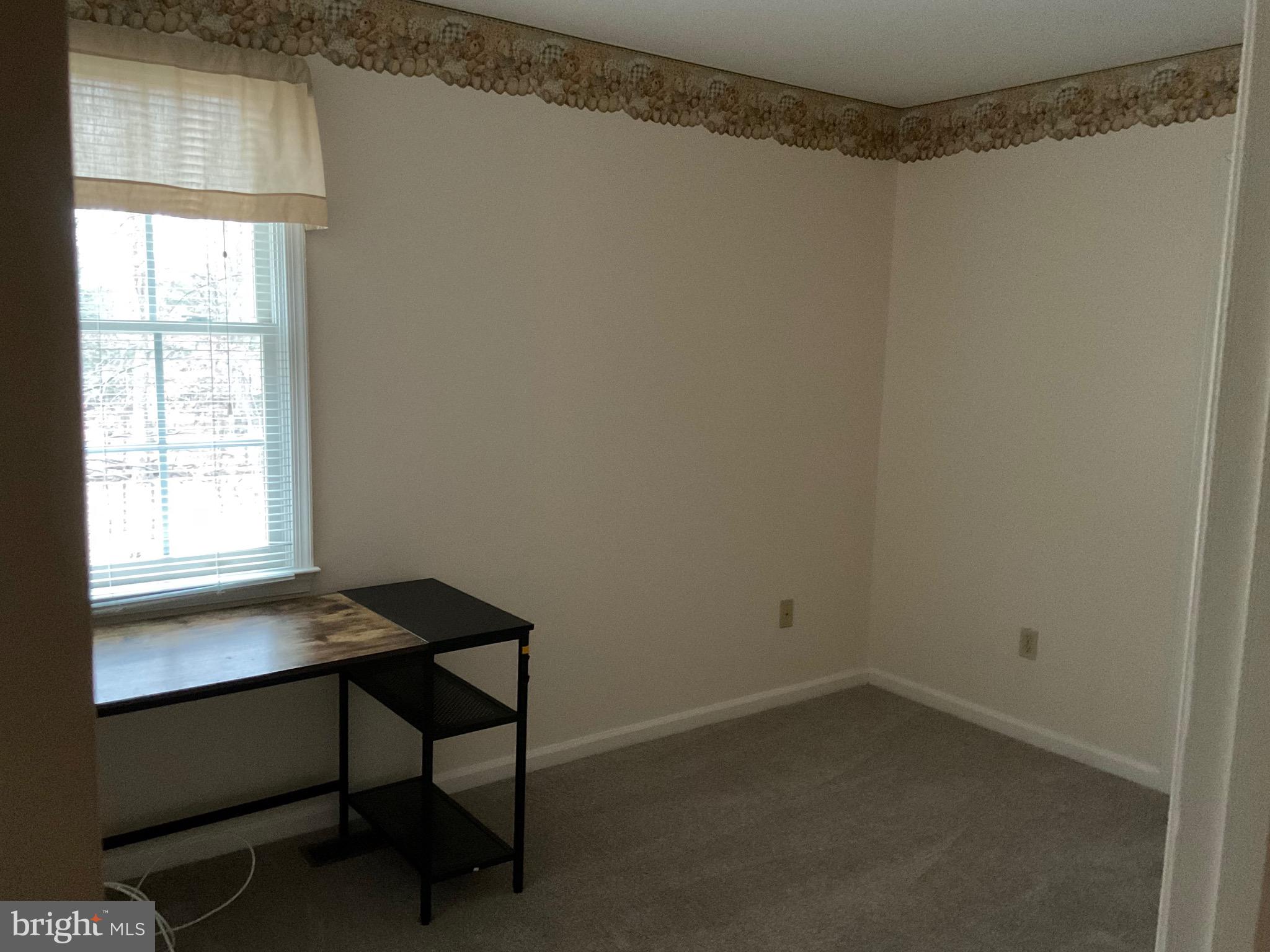 6801 Upper Mills Circle Baltimore, MD 21228 - Photo 27 of 40 a room that has a window and a table in it