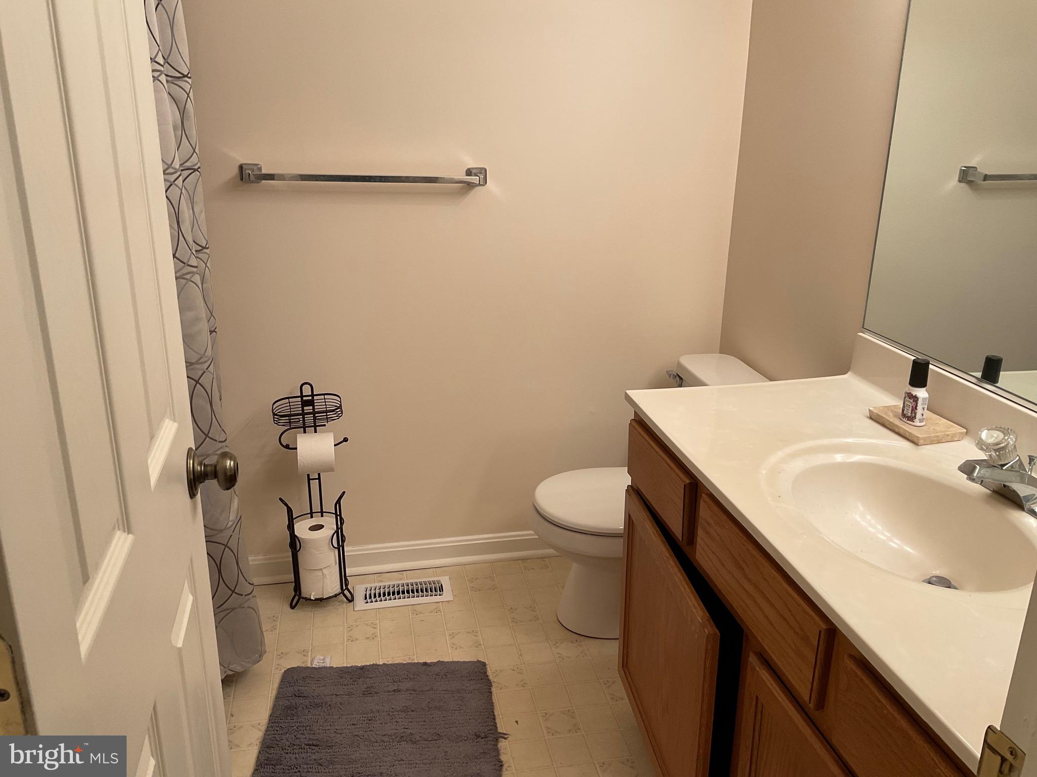 6801 Upper Mills Circle Baltimore, MD 21228 - Photo 28 of 40 a bathroom with a sink toilet and shower