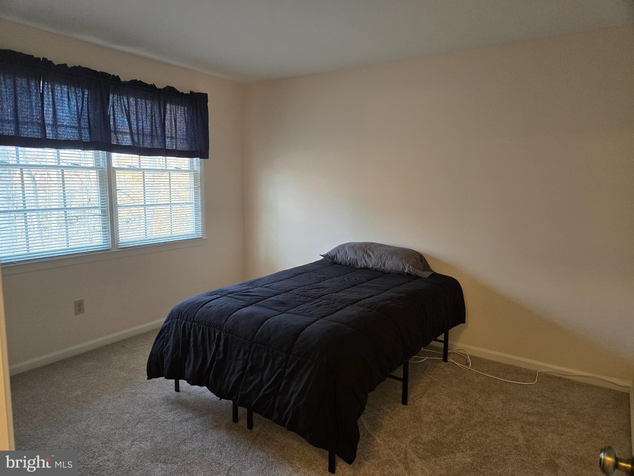 6801 Upper Mills Circle Baltimore, MD 21228 - Photo 31 of 40 a bedroom with a bed and a window