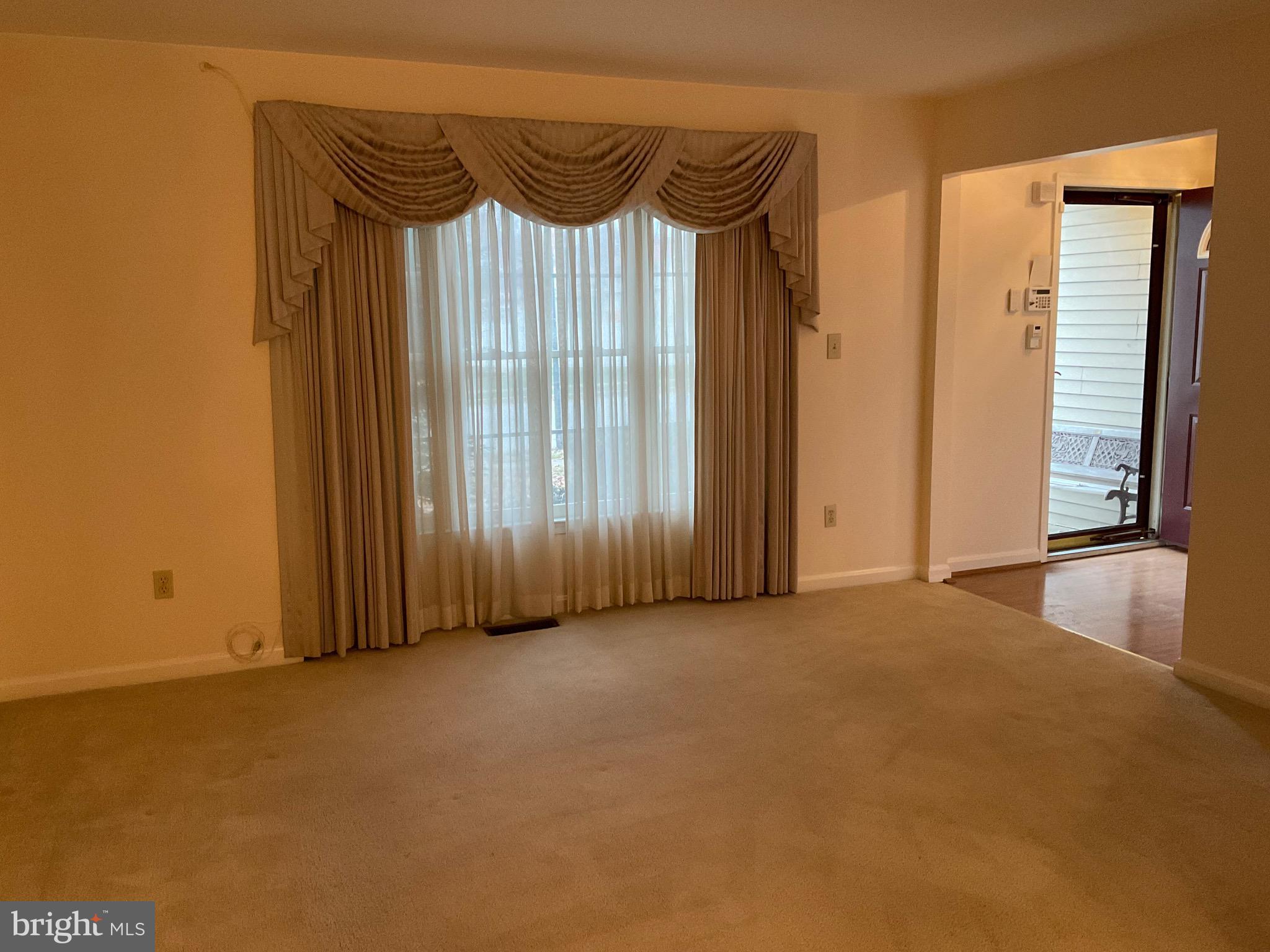 6801 Upper Mills Circle Baltimore, MD 21228 - Photo 6 of 40 a view of an empty room with a sliding door