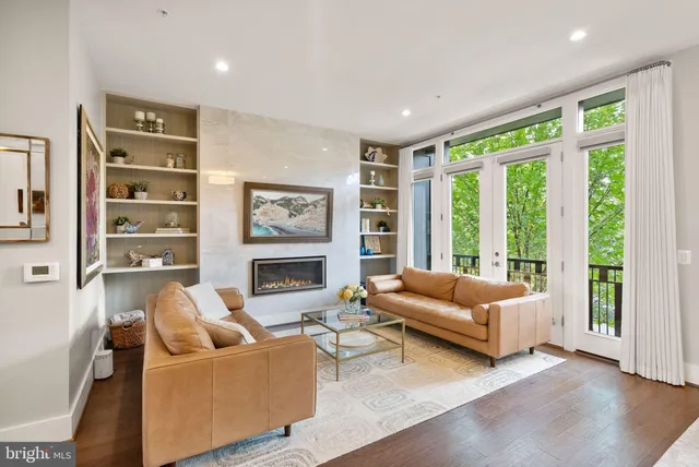 a living room with furniture a rug and a window