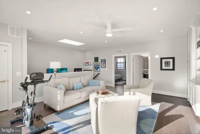 a front view of a building with streets and trees