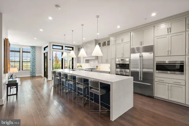 a kitchen with a refrigerator and a stove