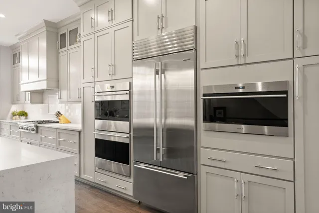 a dining room with table chairs and wooden floor