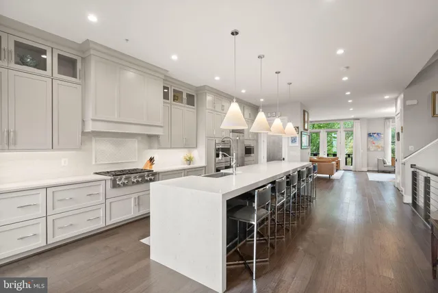 a living room with fireplace furniture and a chandelier