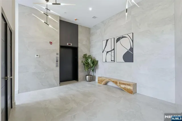 a view of a room with a sink and mirror