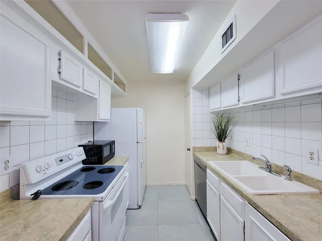 a kitchen with a stove and a refrigerator