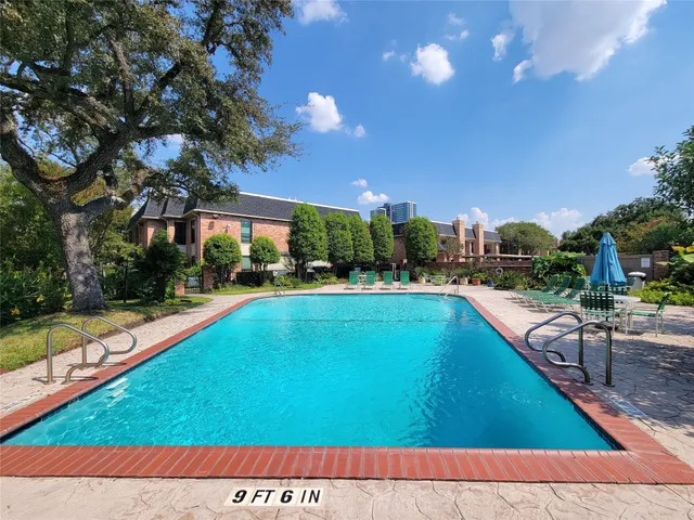 a view of a swimming pool with a patio