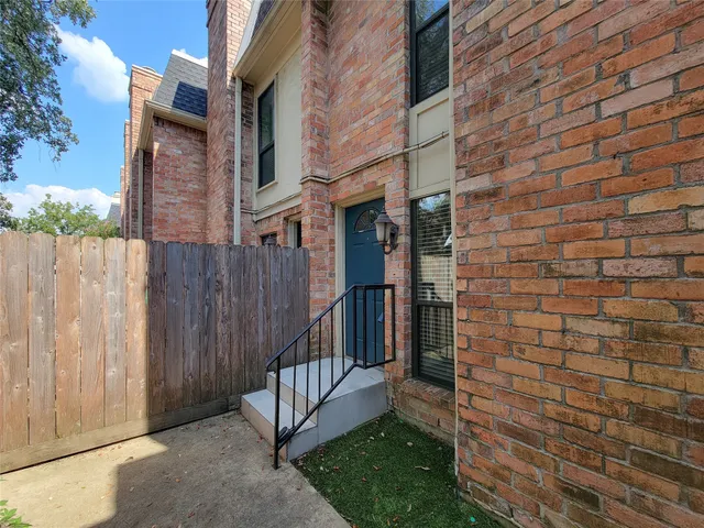 an empty room with fan and fireplace