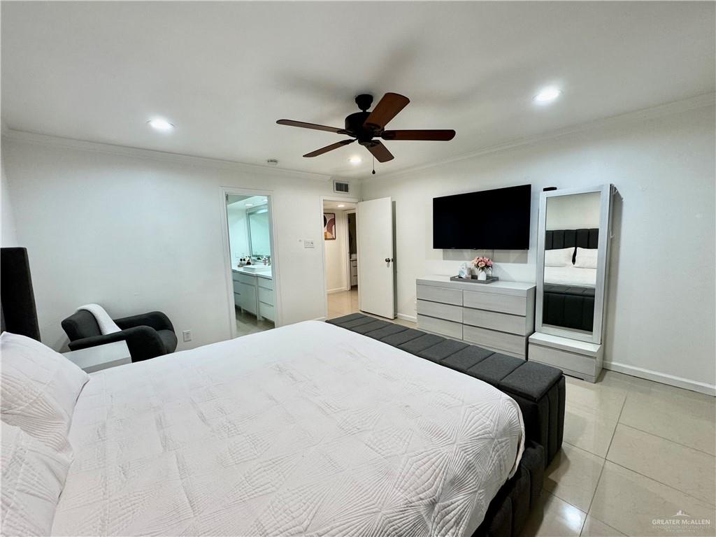 2708 Howard Drive, Unit E3 McAllen, TX 78503 - Photo 18 of 30 a bedroom with a bed and a flat screen tv