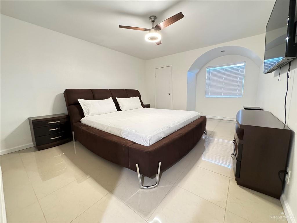 2708 Howard Drive, Unit E3 McAllen, TX 78503 - Photo 22 of 30 a large bedroom with a bed and a flat screen tv