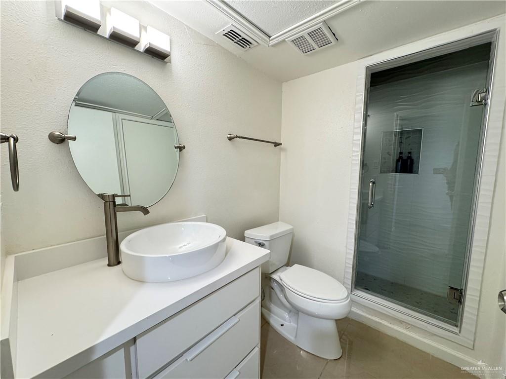 2708 Howard Drive, Unit E3 McAllen, TX 78503 - Photo 24 of 30 a bathroom with a sink a toilet and shower