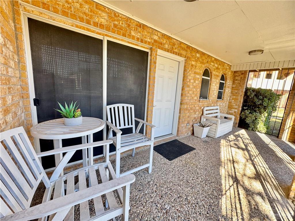 2708 Howard Drive, Unit E3 McAllen, TX 78503 - Photo 3 of 30 a view of a patio with a table and chairs