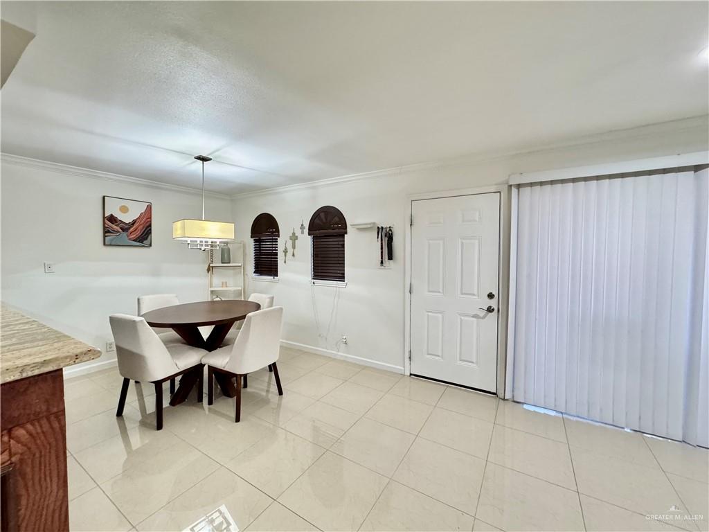2708 Howard Drive, Unit E3 McAllen, TX 78503 - Photo 9 of 30 a view of a dining room with furniture and window