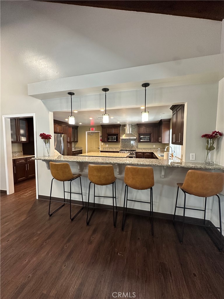 3825 Crestmore Road, Unit 414 Riverside, CA 92509 - Photo 28 of 31 a living room with stainless steel appliances kitchen island granite countertop wooden floor and furniture