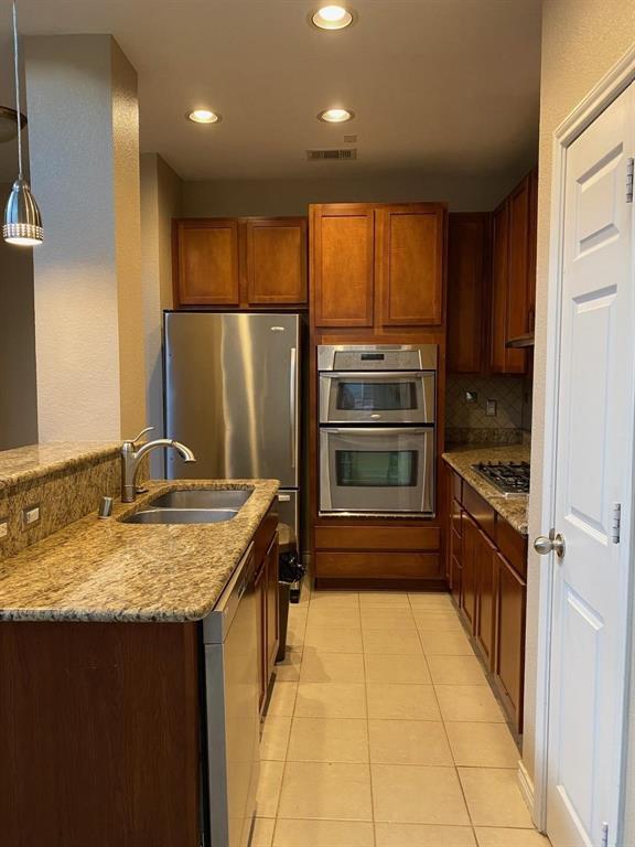 2018 Azure Pointe Richardson, TX 75080 - Photo 3 of 8 a kitchen with kitchen island granite countertop a sink stove and refrigerator