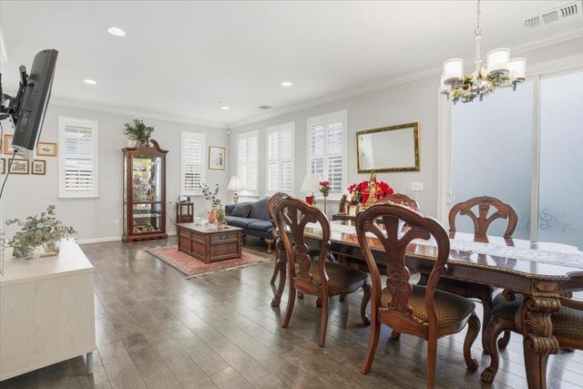 a view of a dining room with furniture wooden floor and chandelier