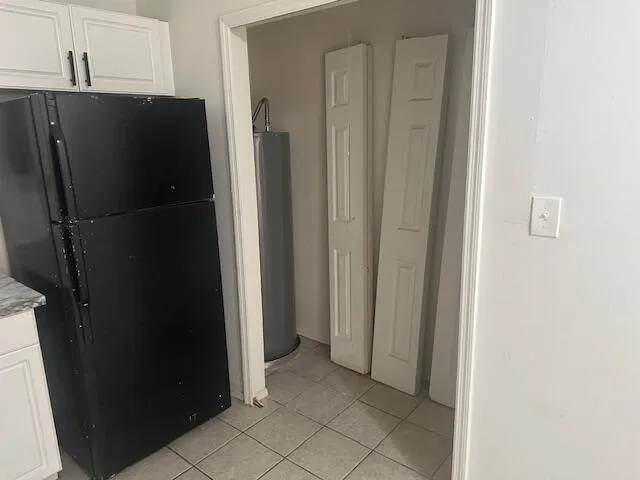 a view of a refrigerator and cabinets