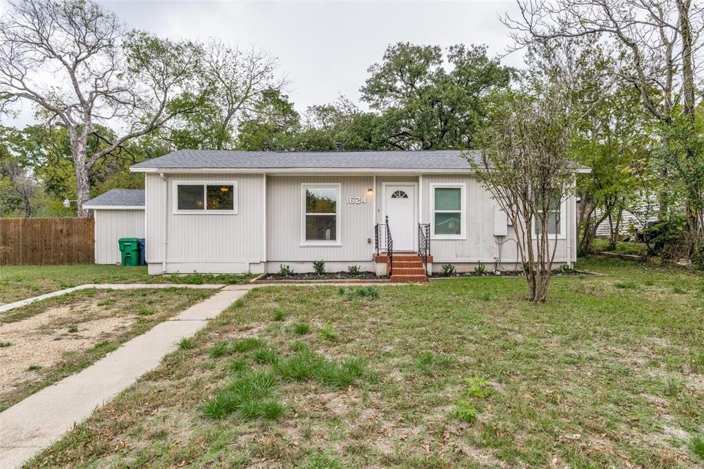 a backyard of a house with barbeque oven
