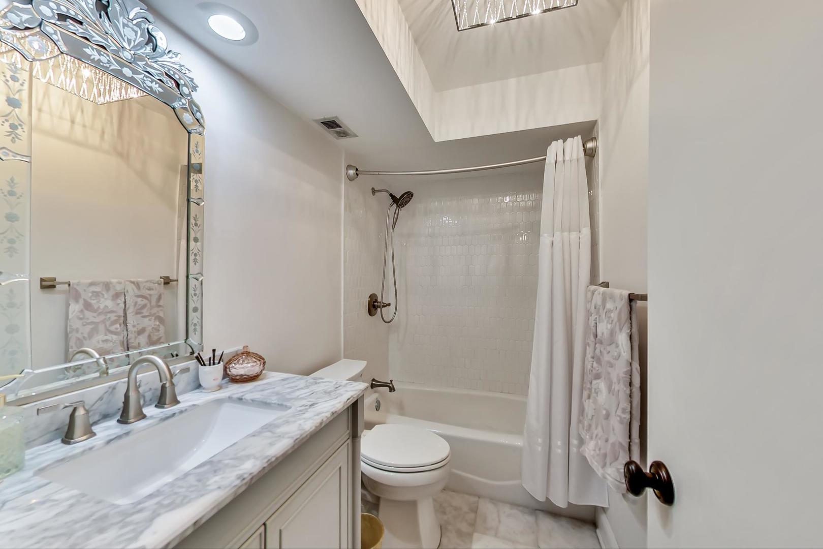 250 Ridge Avenue, Unit 3K Evanston, IL 60202 - Photo 21 of 24 a bathroom with a granite countertop sink toilet and shower