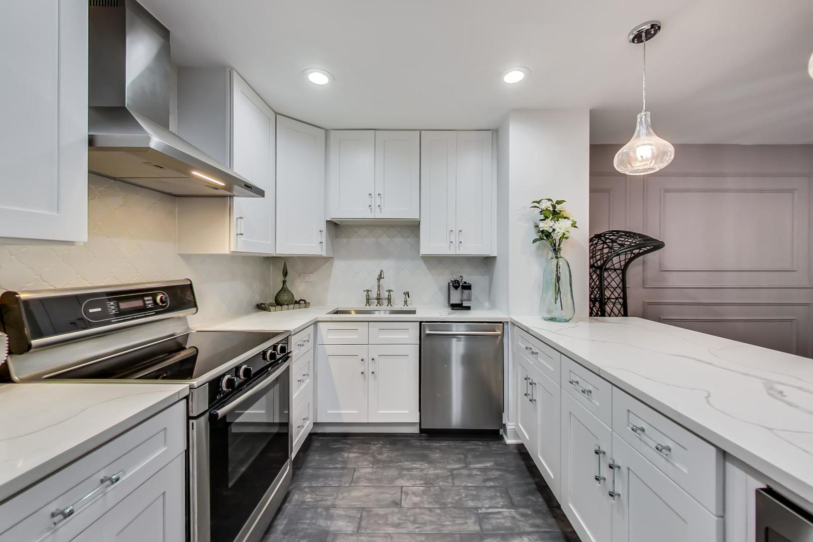 250 Ridge Avenue, Unit 3K Evanston, IL 60202 - Photo 7 of 24 a kitchen with stainless steel appliances granite countertop a sink a stove and cabinets