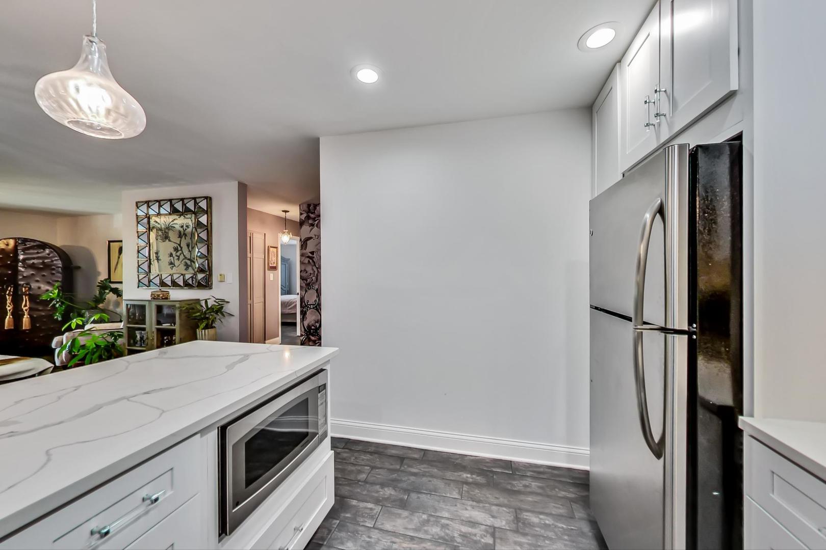 250 Ridge Avenue, Unit 3K Evanston, IL 60202 - Photo 8 of 24 a kitchen with stainless steel appliances a refrigerator sink and microwave