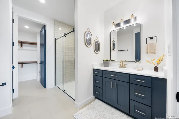 a bathroom with a double vanity sink and a mirror