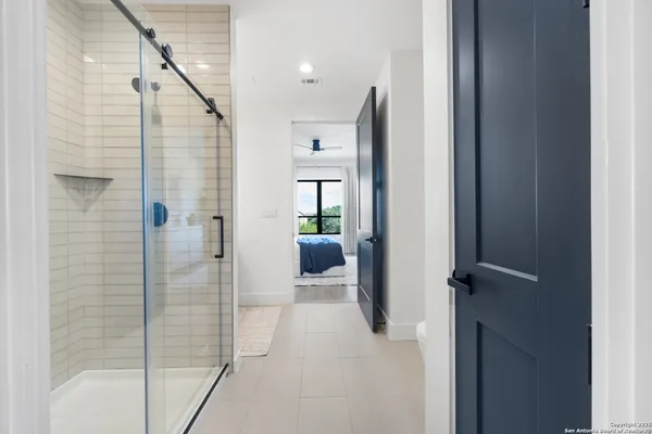 a bathroom with a shower and a mirror