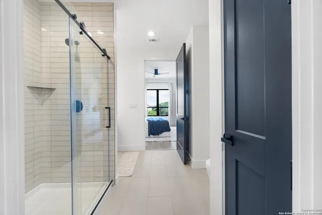 a bathroom with a shower and a mirror